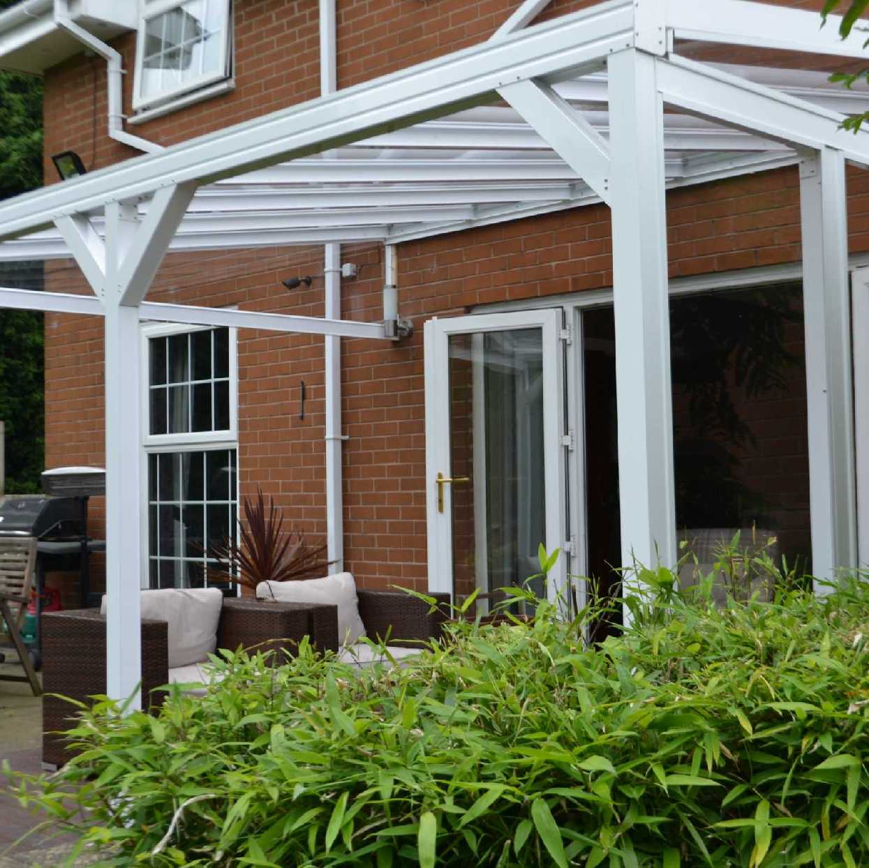 Omega Smart Lean-To Canopy, White with 6mm Glass Clear Plate Polycarbonate Glazing - 9.1m (W) x 2.0m (P), (5) Supporting Posts from Omega Build